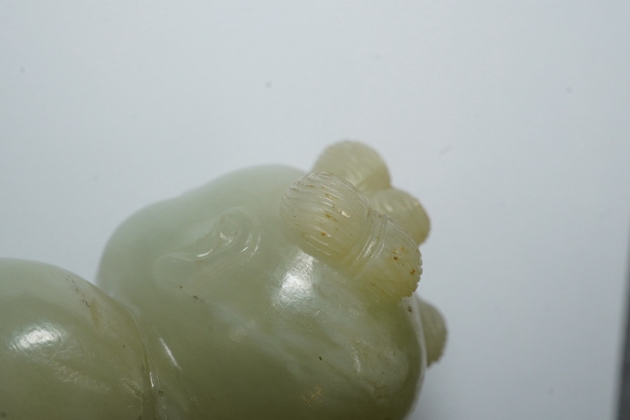 A Chinese pale celadon jade figure of a boy, 18th century